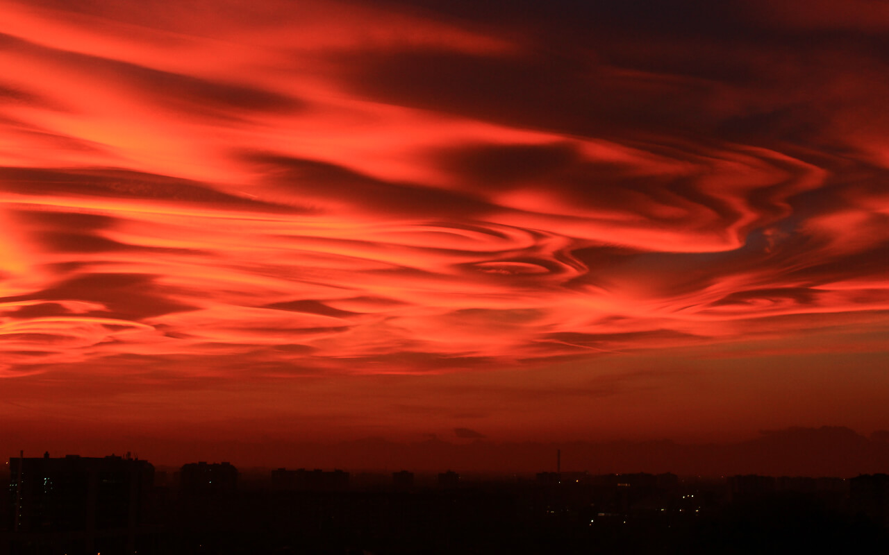 Forest fires in the Alps coloured the Milanese evening skyscape a deep red